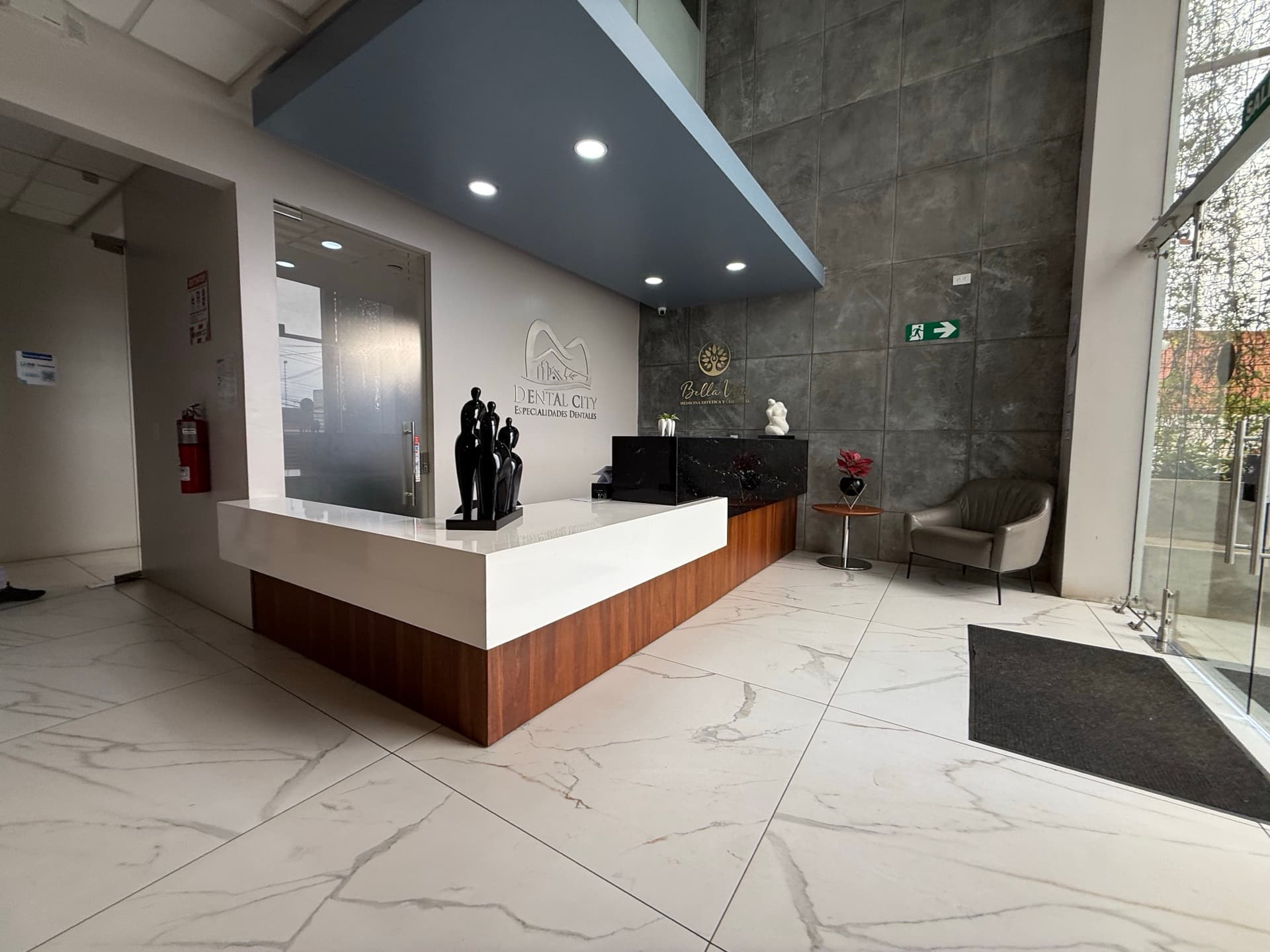 Modern reception lobby with Dental City branding and marble floors