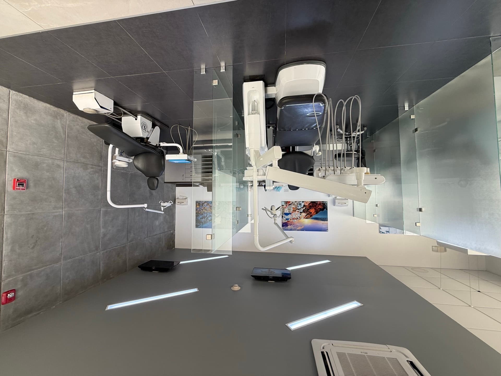 Upstairs open treatment bay with multiple stations and glass partitions